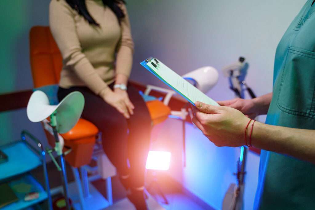 Gynecologist examining a patient at clinic, health care concept