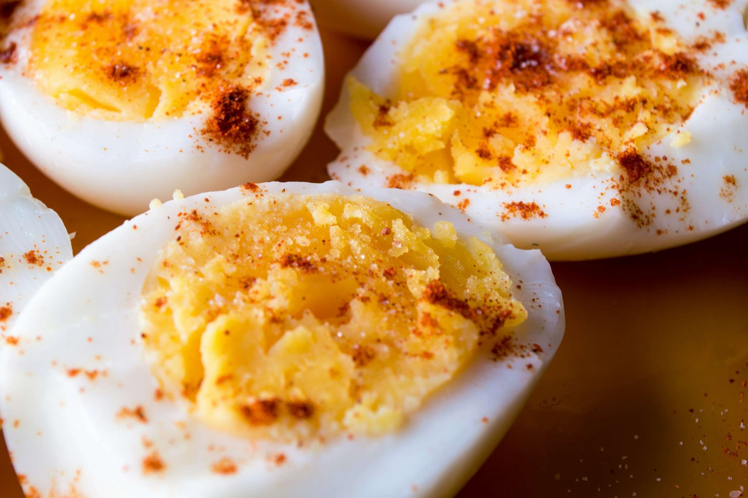 Sliced boiled eggs topped with spices